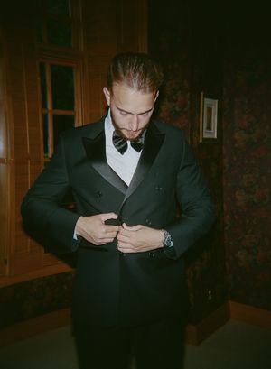 A series of photos showing a groom adjusting his formal black bowtie and suit.
