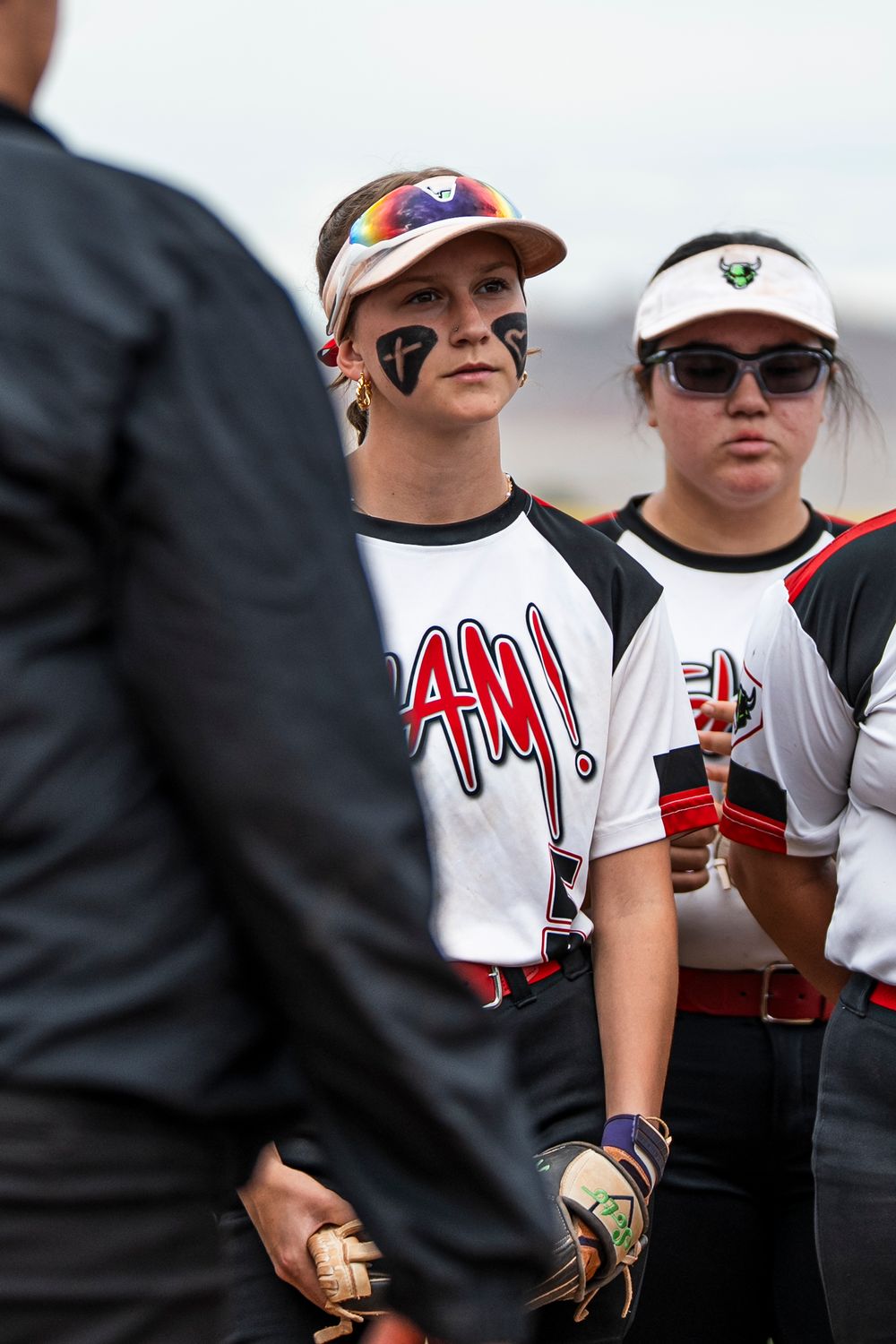 Girls softball player looking at coach