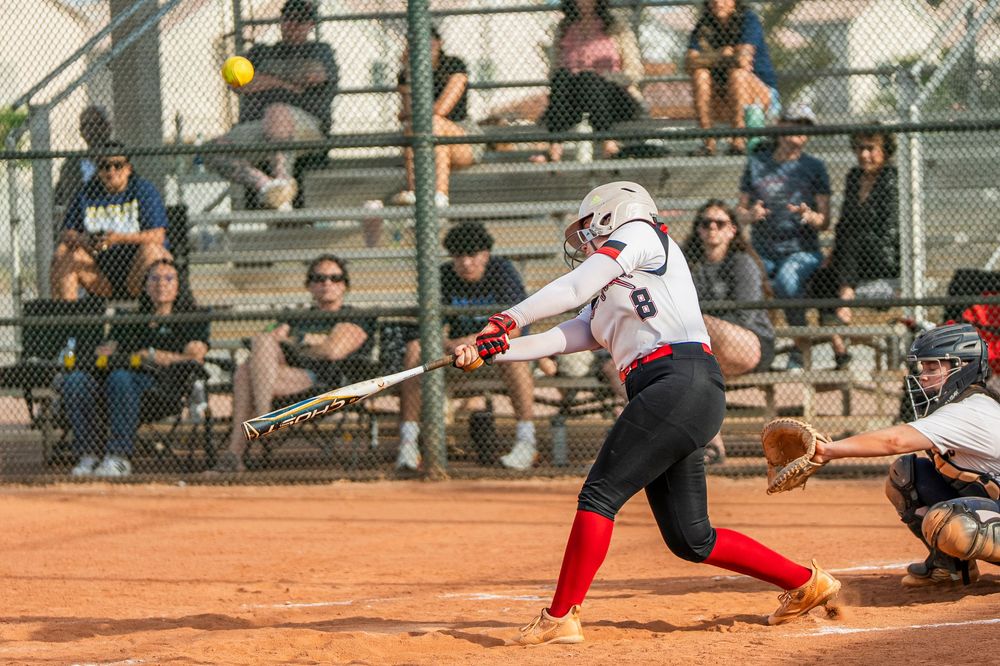 Girls softball player hitting the softball