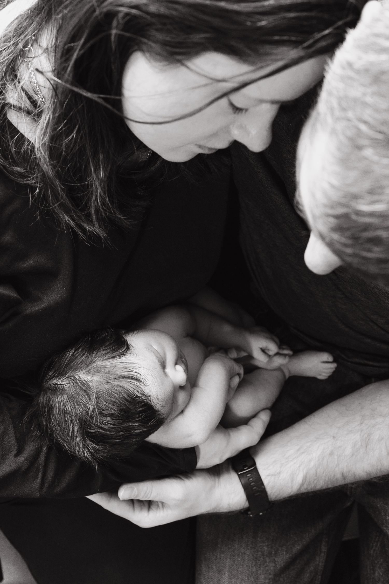Intimate black and white photograph showing tender family moments.