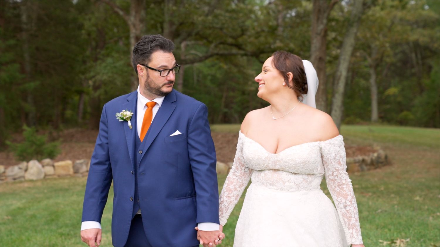 Couple sharing a romantic moment in an outdoor garden setting.