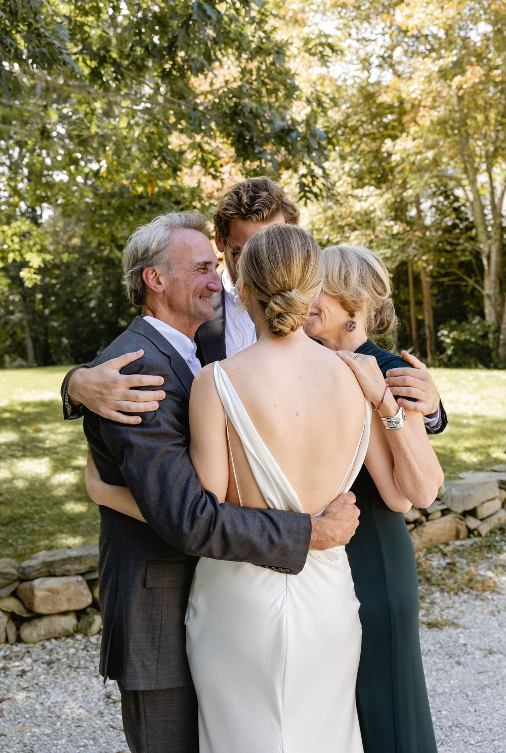 An emotional embrace shared during an outdoor wedding ceremony. Weatherlow Farm wedding. Westport Massachusetts.