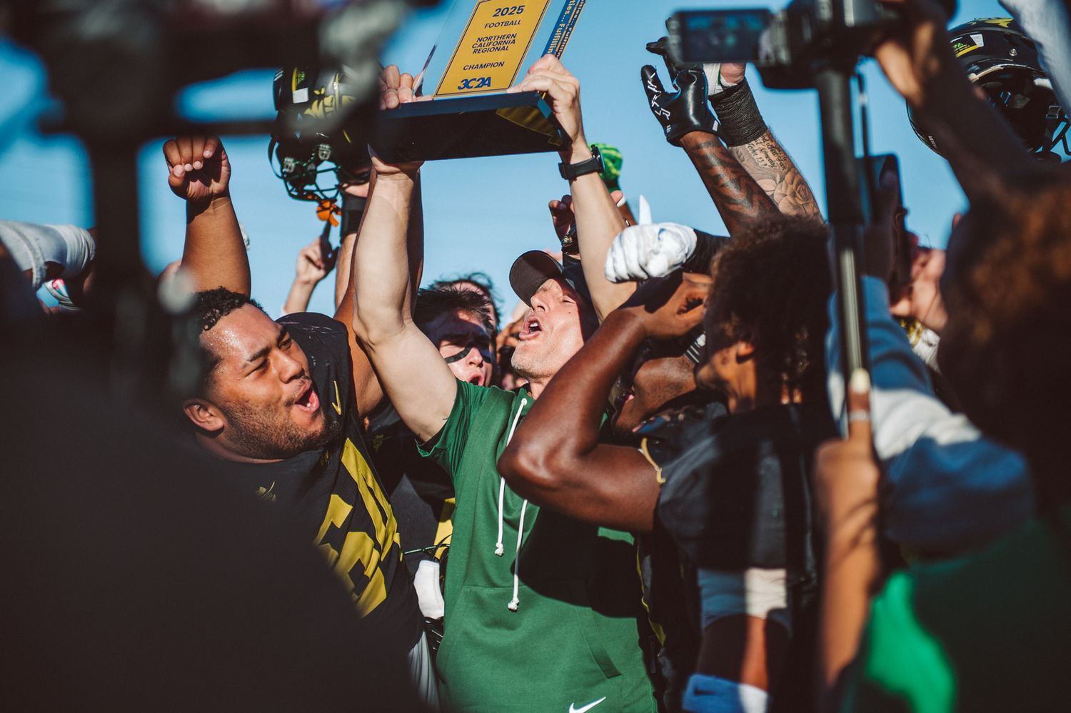 Golden West College football coach celebrates after winning the Southern California Football Championship game over Saddleback College.