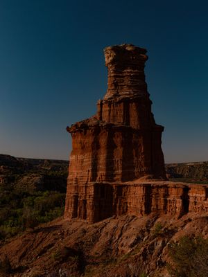 The Lighthouse rock formation stands tall against a deep blue sky at Palo Duro Canyon State Park in Texas.