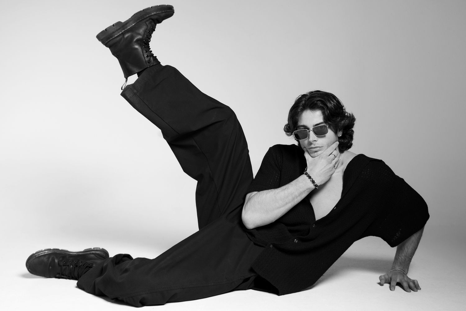 Black and white fashion photography sequence showing dynamic poses on light background.
