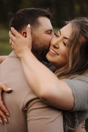 Close-up sequence of romantic couple sharing tender moments and laughter in a natural setting.