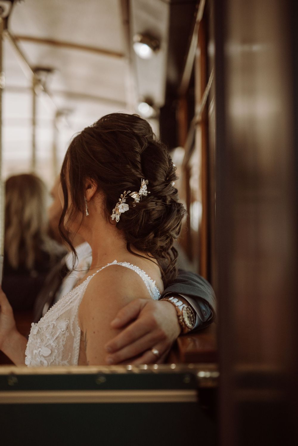 Close-up detail of ornate bridal hairstyle with crystal hair accessories.