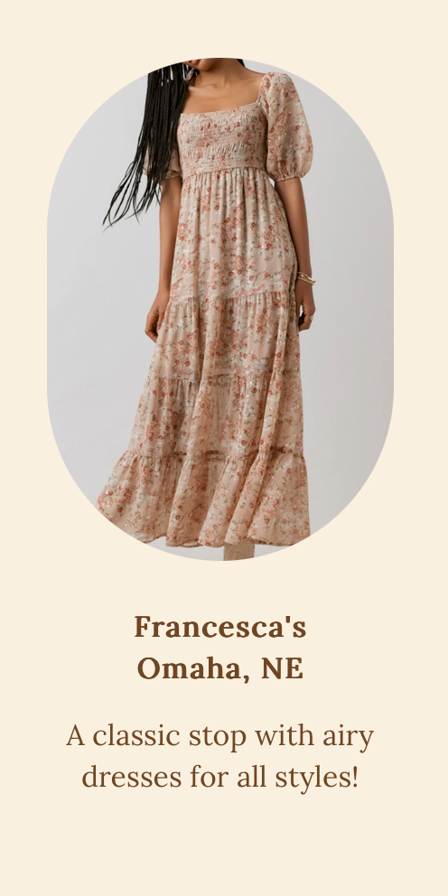 Floral empire waist maxi dress with puff sleeves in beige and pink tones against arched background.