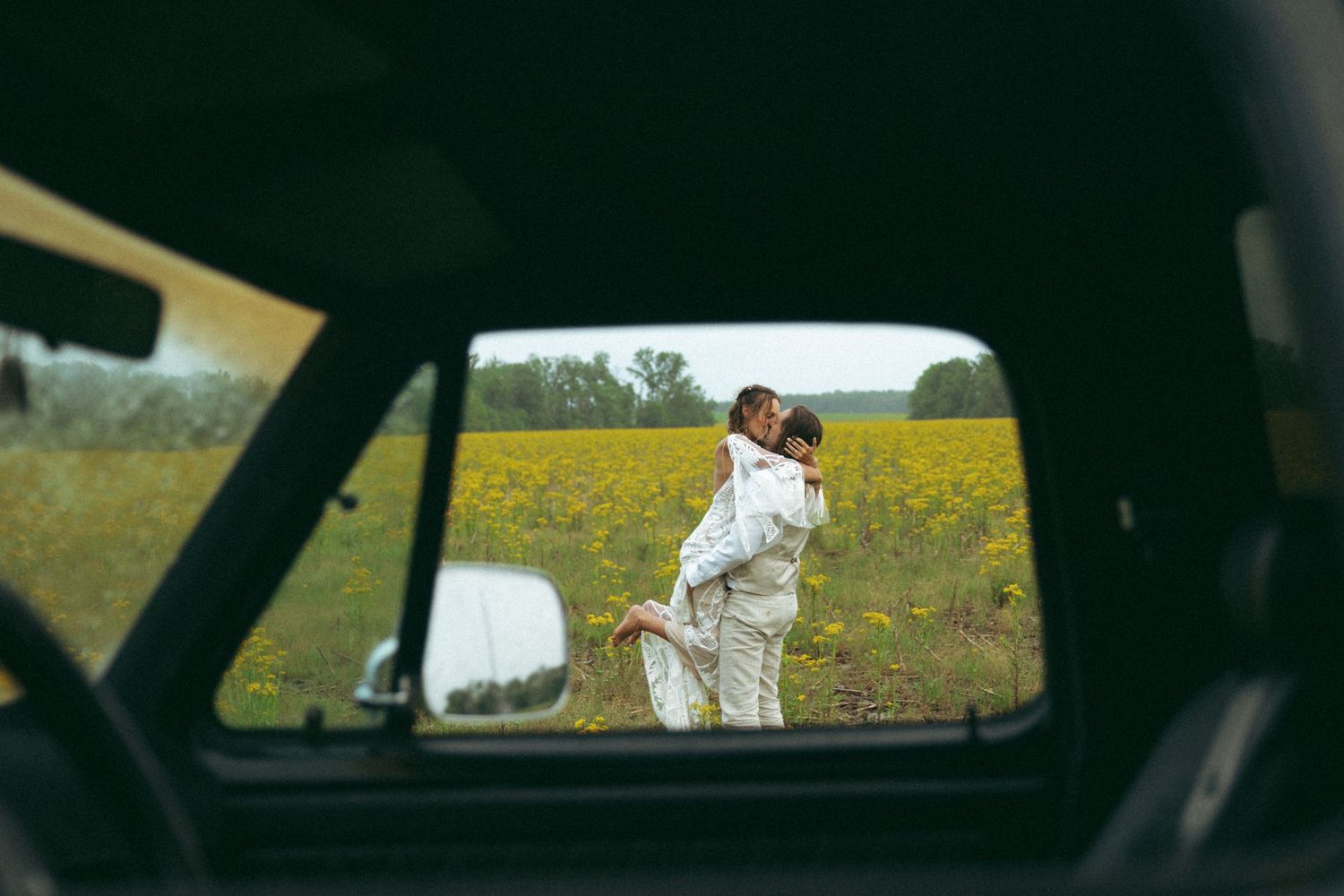 A romantic wedding portrait of a couple embracing in a lush vineyard.
