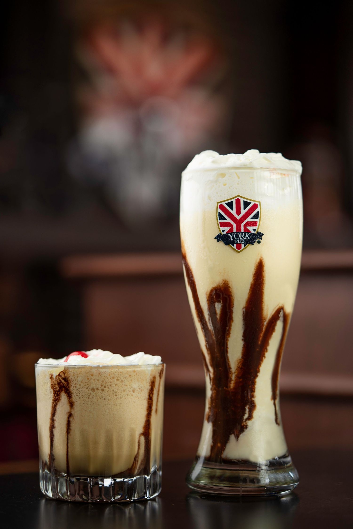 Beer glasses filled with dark and creamy stout showing distinctive layered effect.