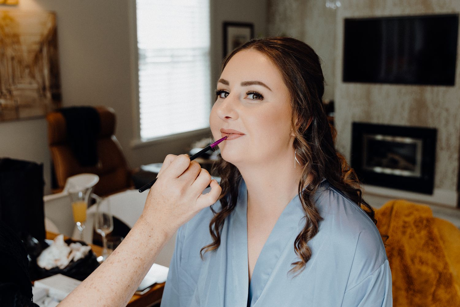Bride wearing a light blue robe during her wedding prep, captured by Apertured Media Auckland Wedding Photographer.