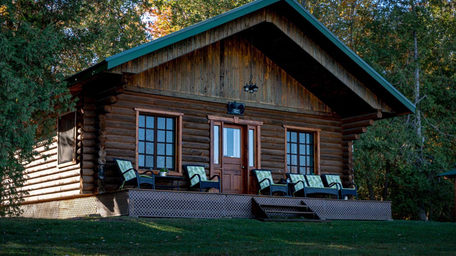 Close-up of cottage on the cottage deck with a peaceful, scenic forest view at Domaine Labrador in Clarence Creek, Ontario.