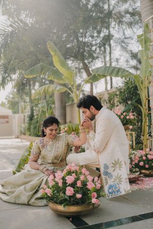 Garden wedding setup with pink roses and tropical foliage creating a romantic outdoor atmosphere.