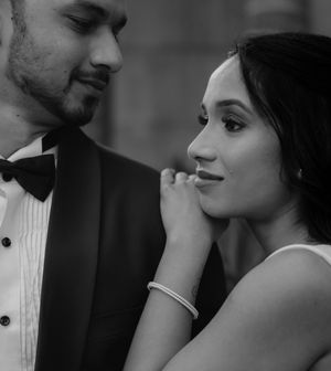 Black and white close up photo of a romantic couple in formal attire sharing an intimate moment.