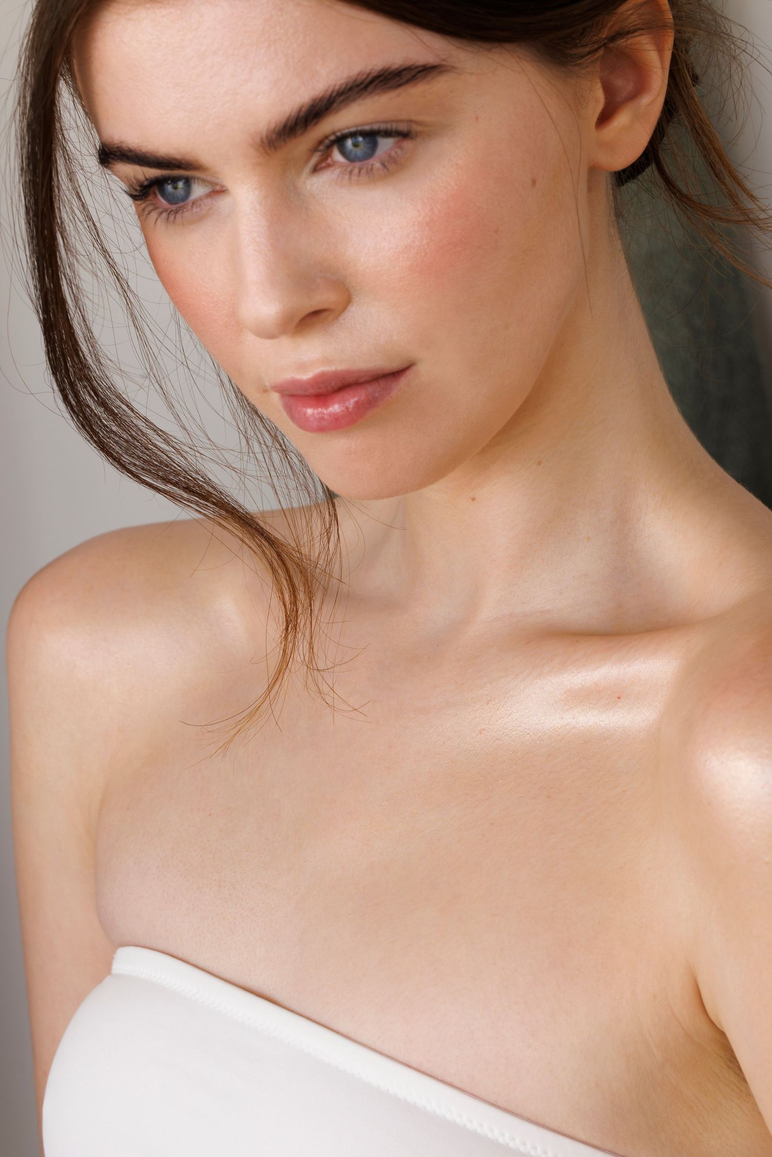 Close up beauty portrait showcasing natural glowing skin and makeup.