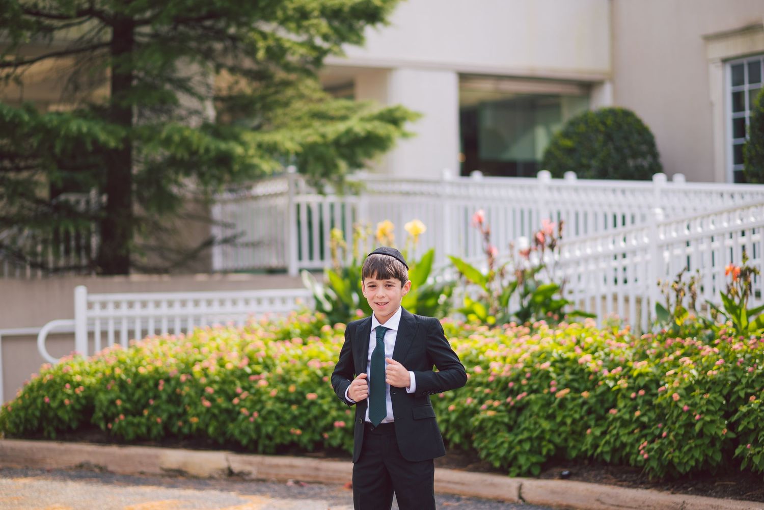 White picket fence and landscaping outside an elegant venue entrance.