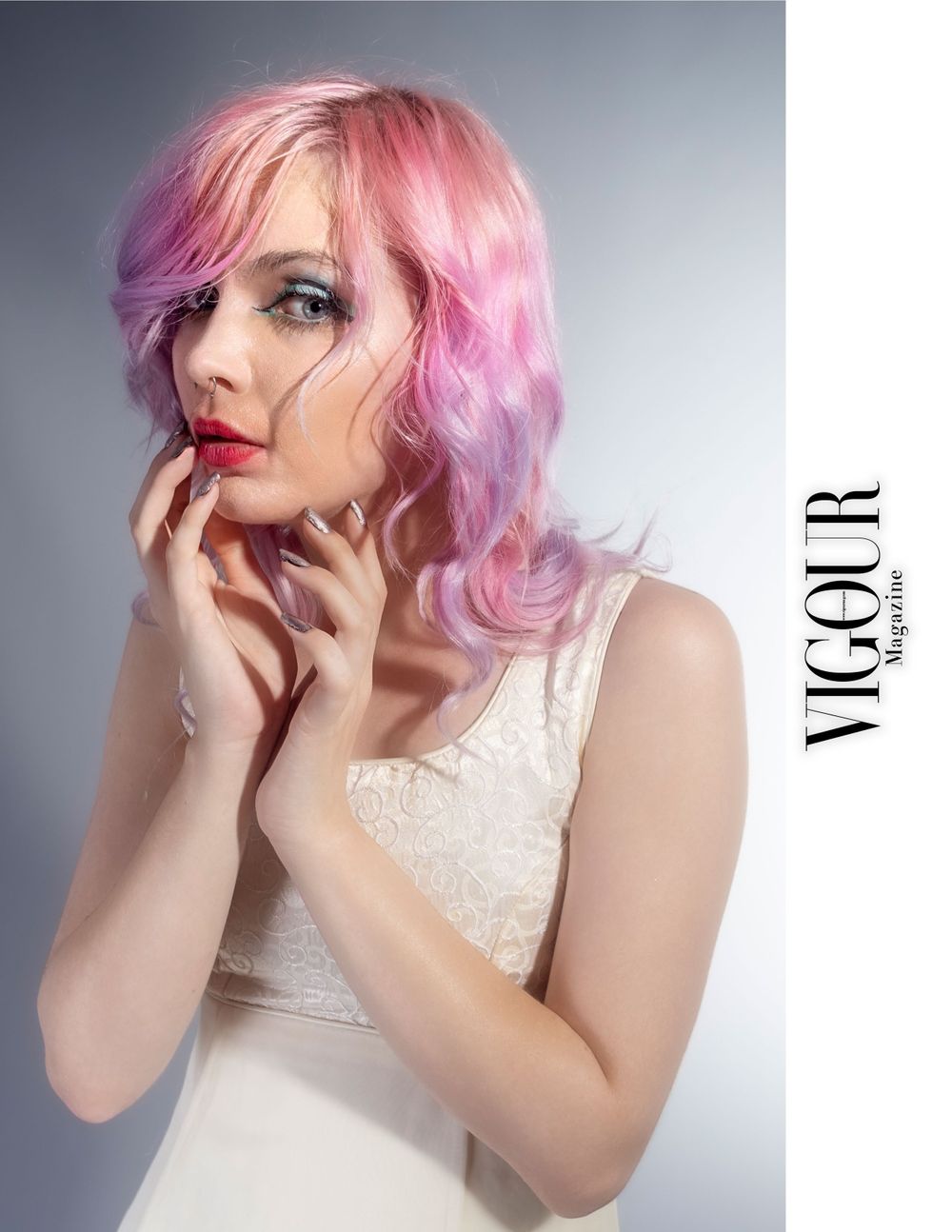 Beauty shot featuring soft pink wavy hairstyle and white lace top. Photographer for publications.