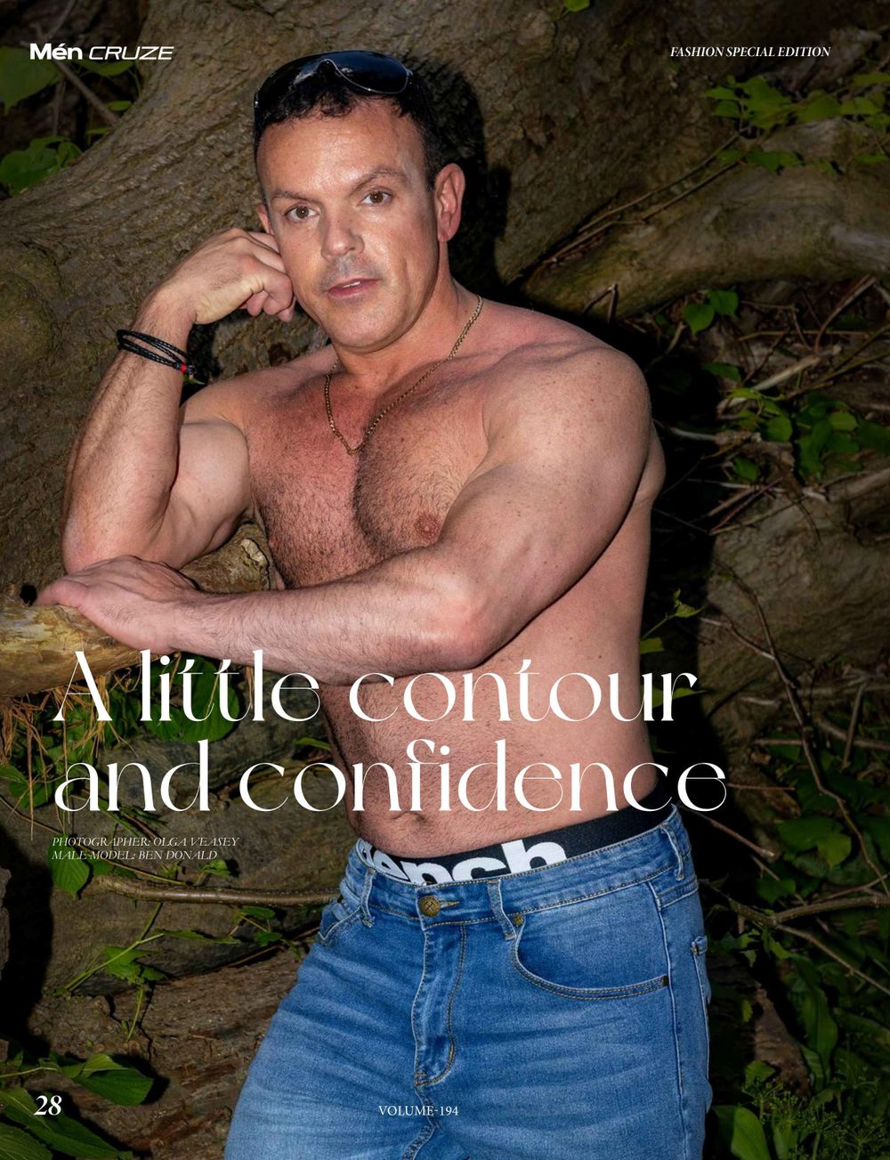 Shirtless man in jeans poses against natural backdrop for magazine feature. Best photographer for men.