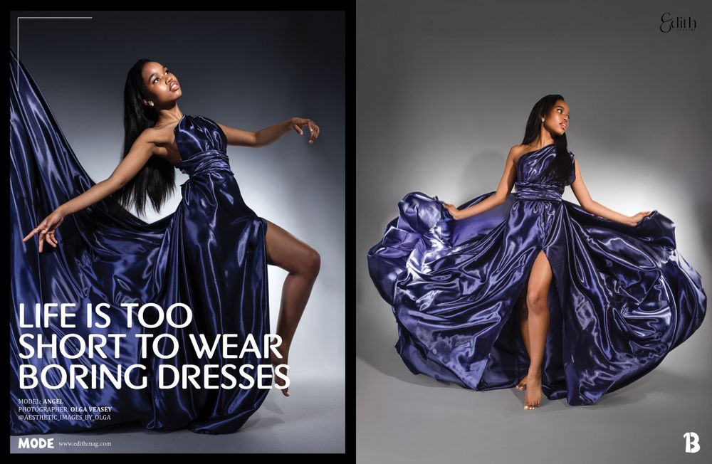A model poses dramatically in a flowing royal blue satin evening gown with high slit against a gray studio backdrop.