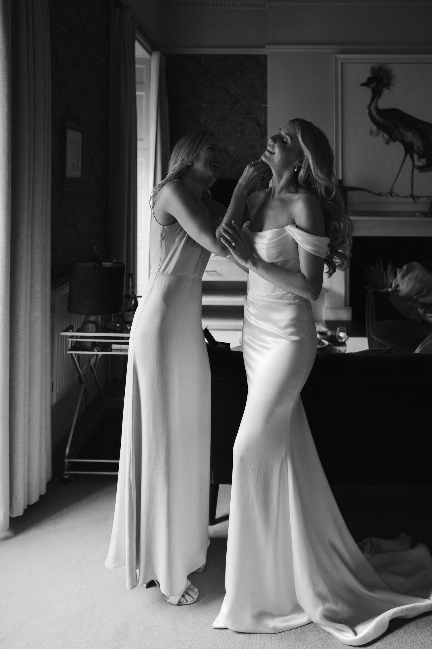 bridesmaid fastening brides earrings at the Queensbury hotel in bath