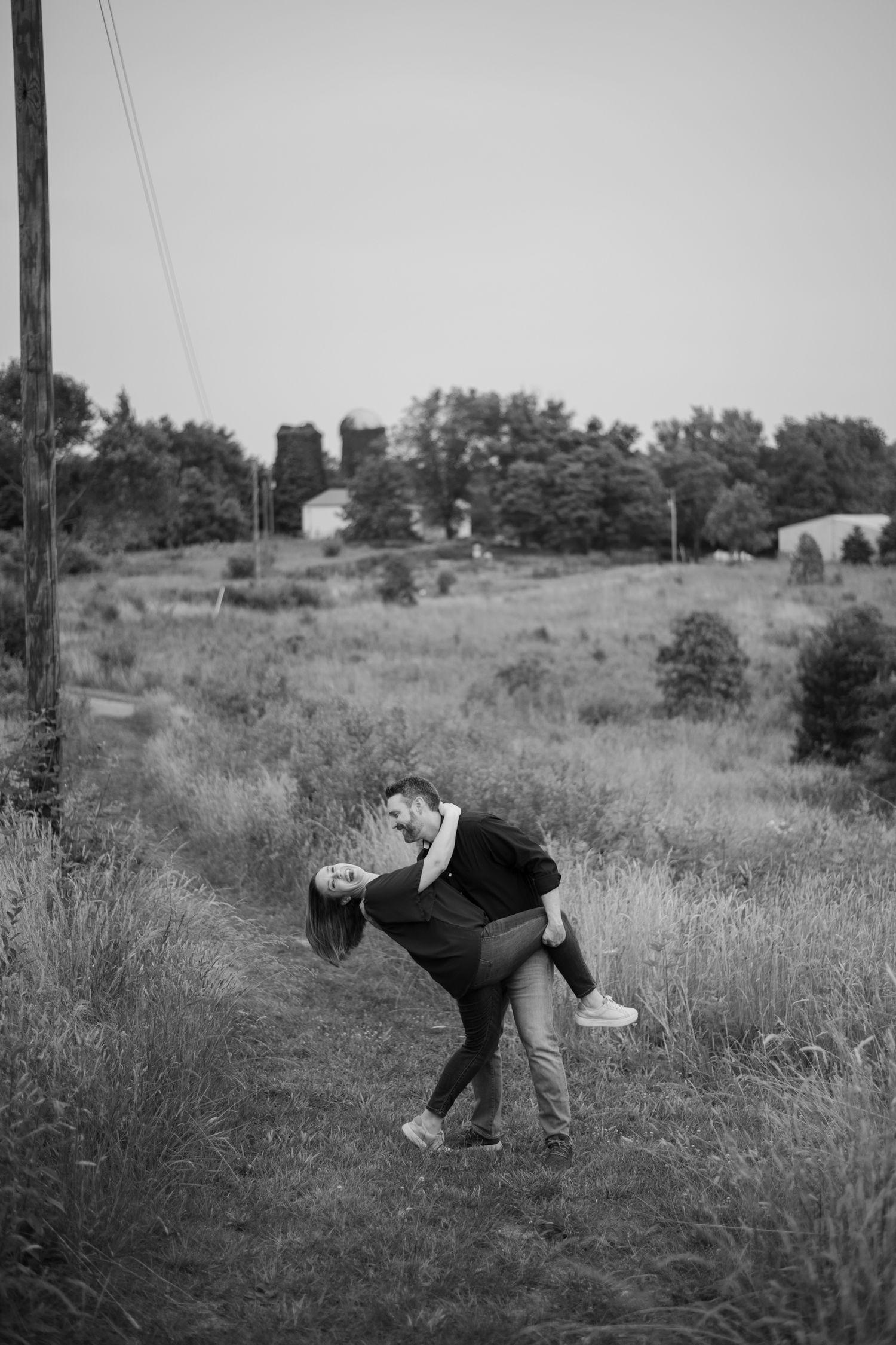 Romantic black and white photo of couple dancing in rustic field. Banshee Reeks Nature Preserve