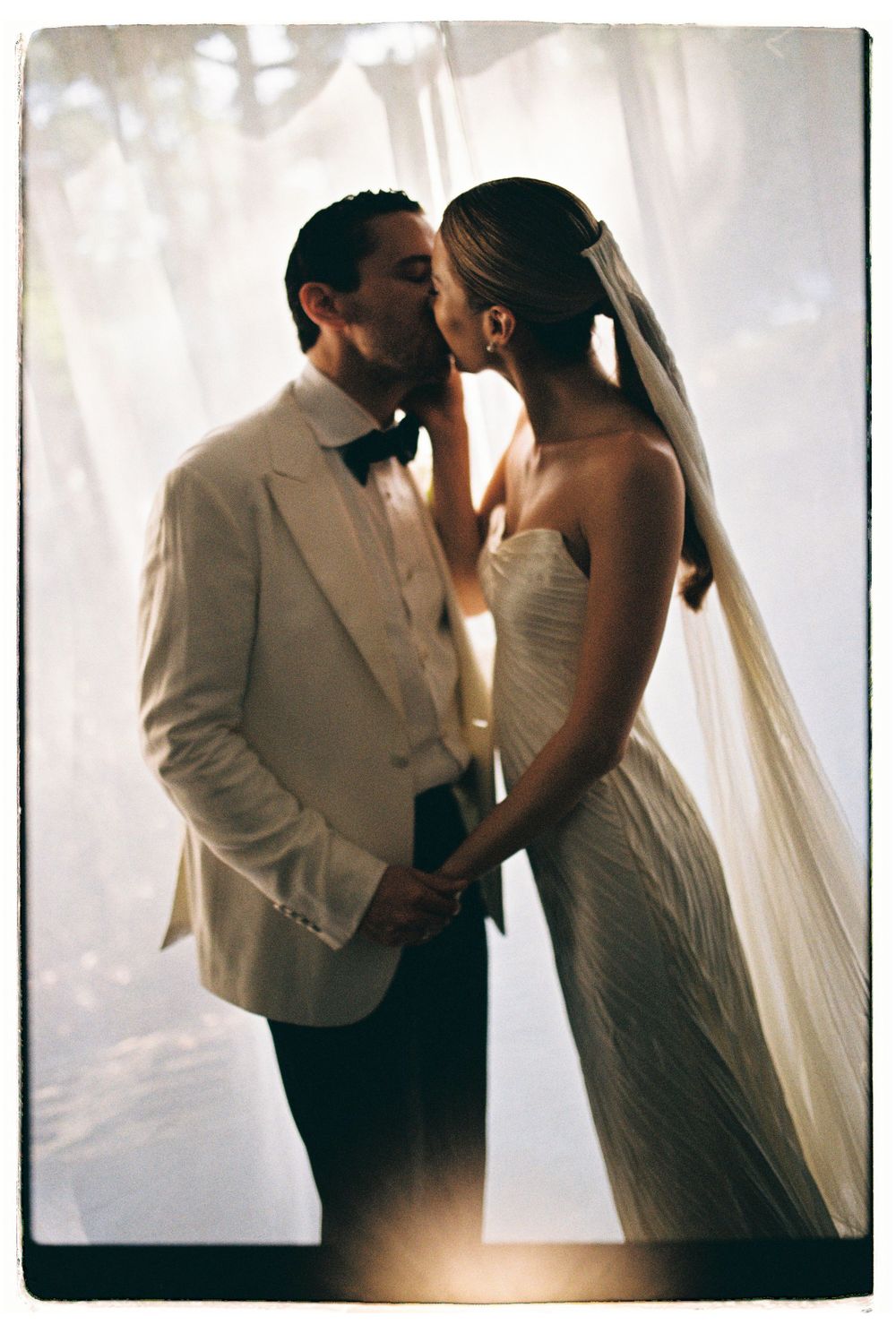 Romantic wedding portrait of couple sharing intimate moment.