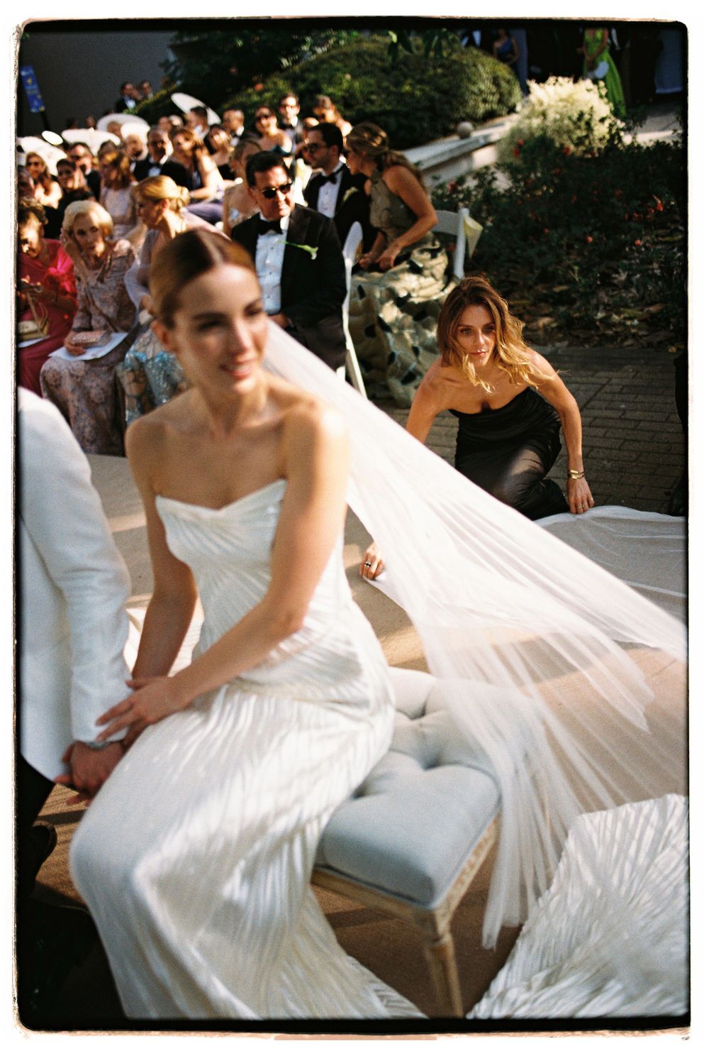 Wedding celebration scene with flowing white dress and veil.
