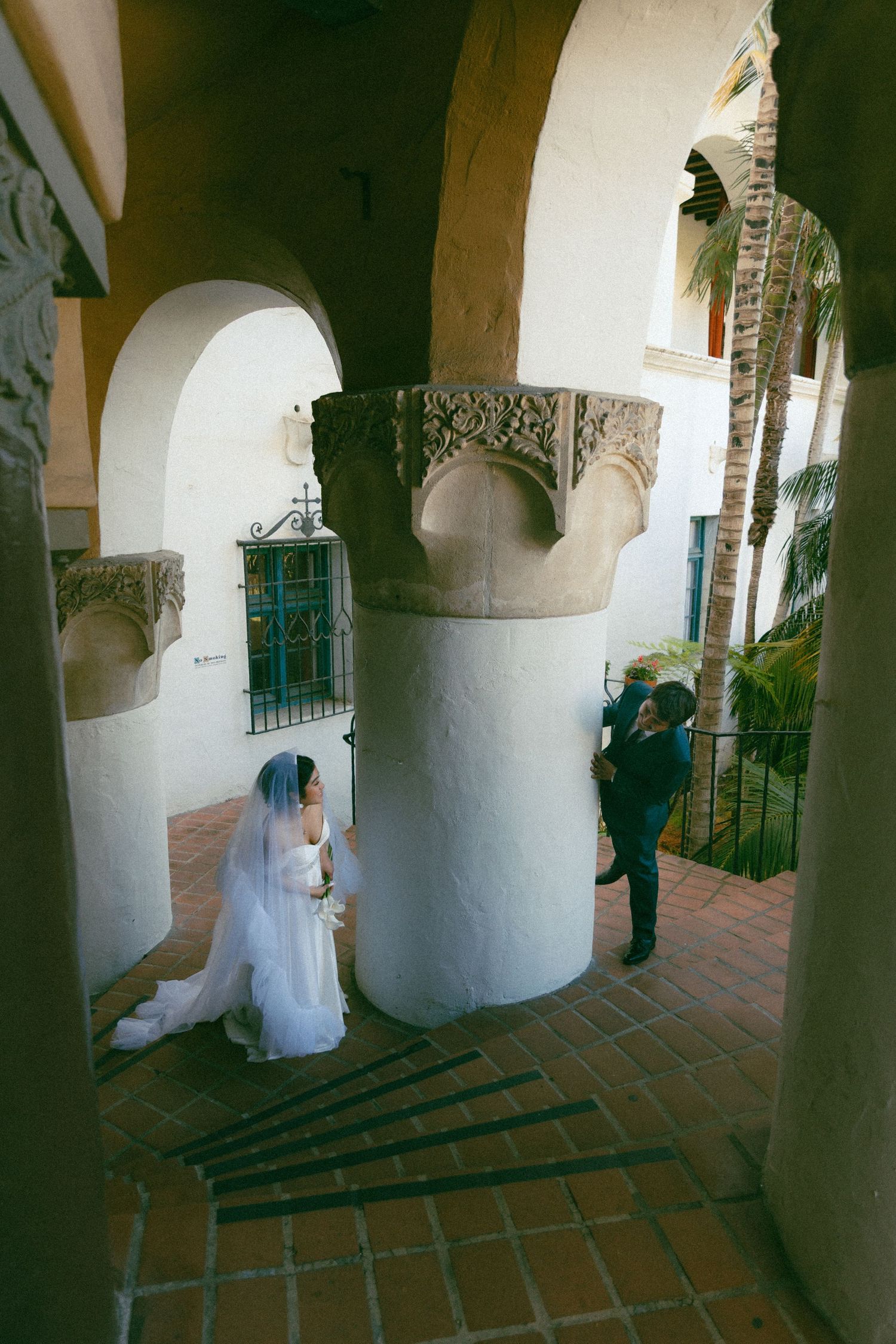 Blurred vintage-style photo of a couple dancing at a wedding reception in an ornate indoor venue.