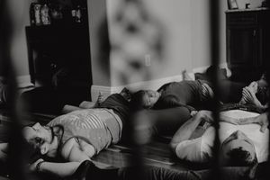 People lying on the floor during an expressive movement workshop in black and white.