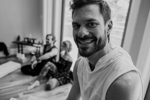 A casual portrait in black and white showing a warm smile.