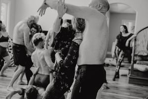 Dancers in motion captured in black and white during an energetic studio session.