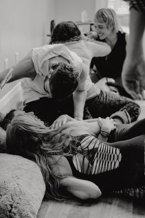 Black and white photo of dancers practicing contemporary dance moves on the floor.