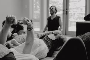 Black and white candid shot of people laughing during a group movement session.