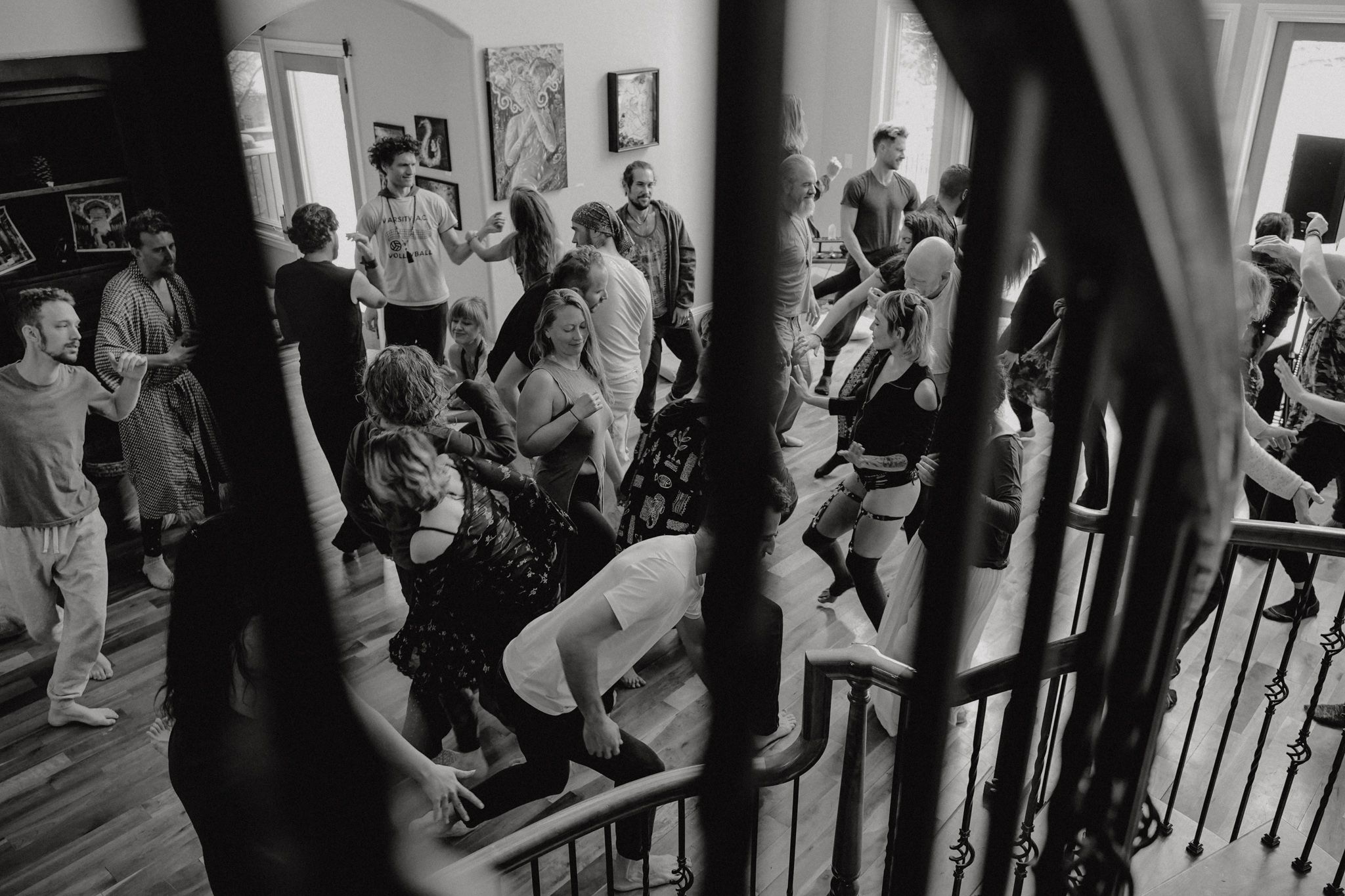 Crowded dance floor with people gathering in an indoor event space.