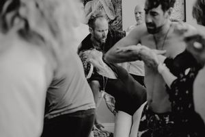 People engaged in dynamic movement exercises during a dance workshop.