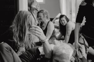 Candid black and white image of people engaging in an interactive movement workshop.