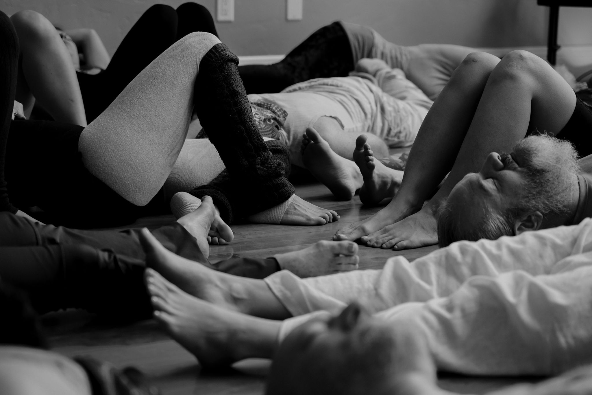 People lying down and relaxing together during a group session or workshop.
