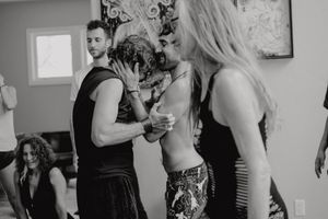 Black and white shot of dancers in casual attire during a dance workshop or practice session.