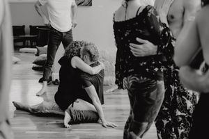 People participating in an expressive movement session on a wooden floor.