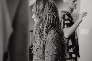 A side profile shot of long-haired dancers in black and white.