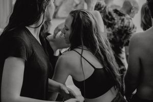 Intimate black and white photo of dancers in close proximity during a dance moment.