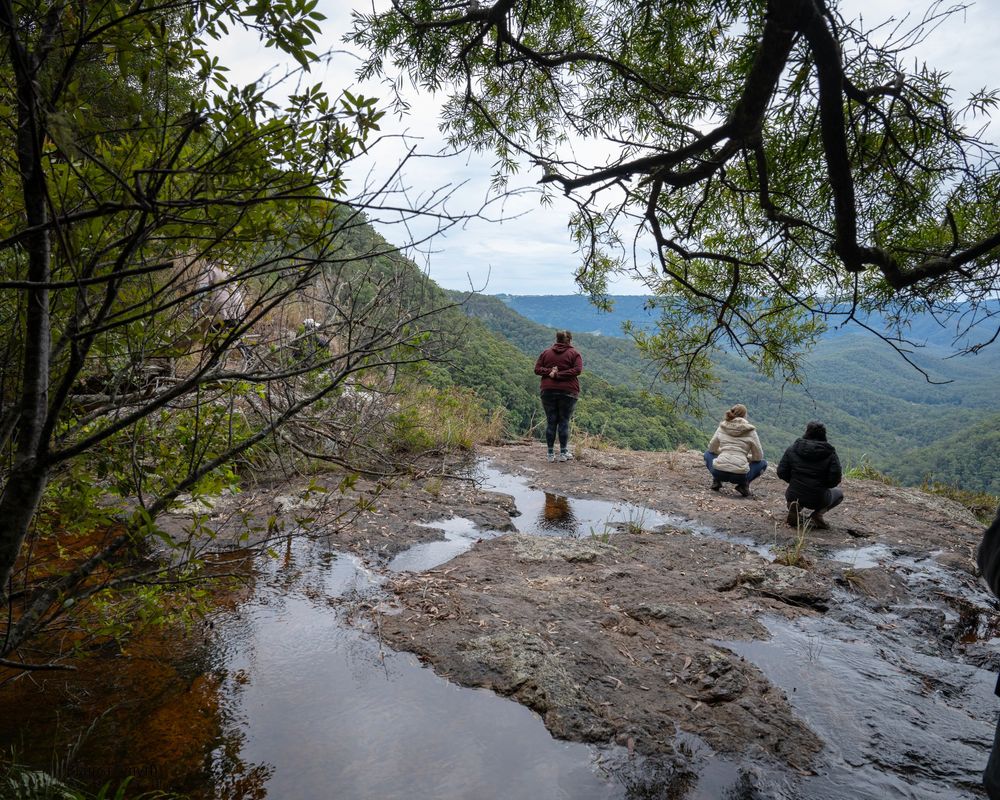 People enjoying some solitude by a waterfall