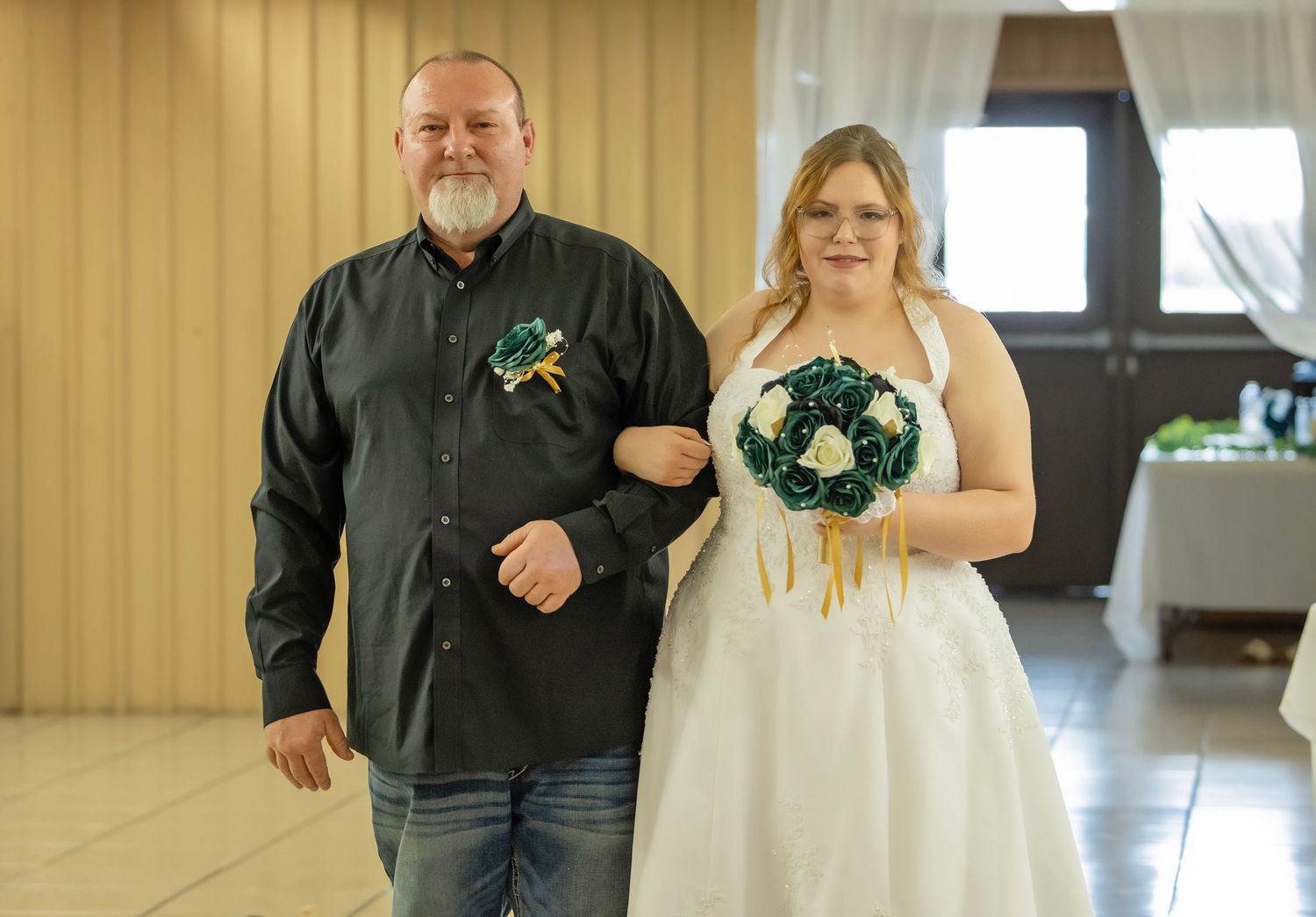 Wedding ceremony bride walking down the aisle with father.