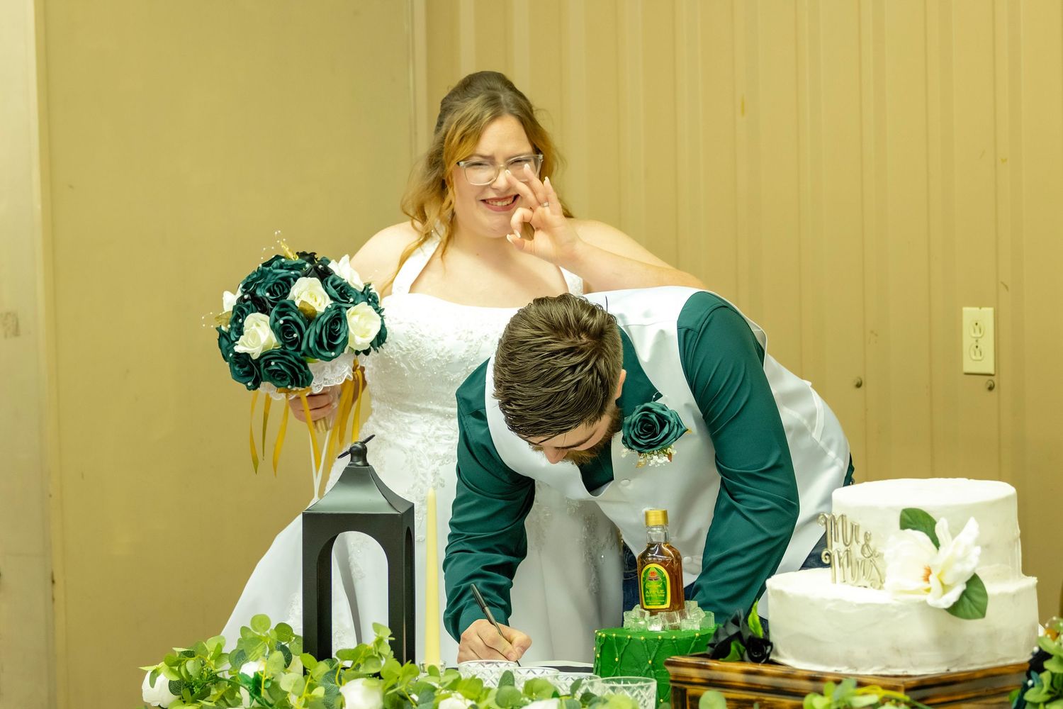 Bride making a joke about catching the right groom signing the marriage license.
