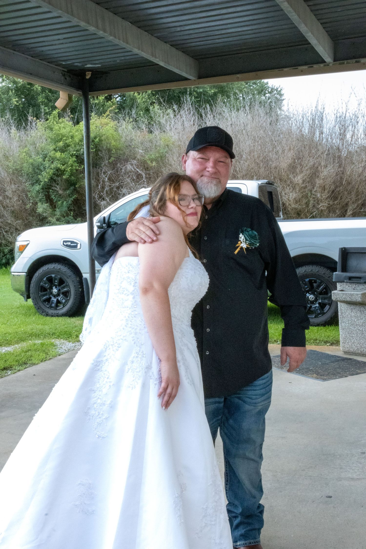Emotional moments shared under a covered outdoor area during first look with father of the bride.