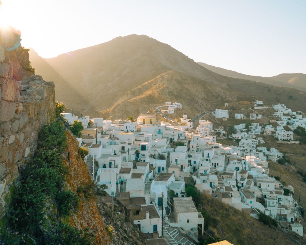 Hillside village with white houses and mountains in the background.Serifos