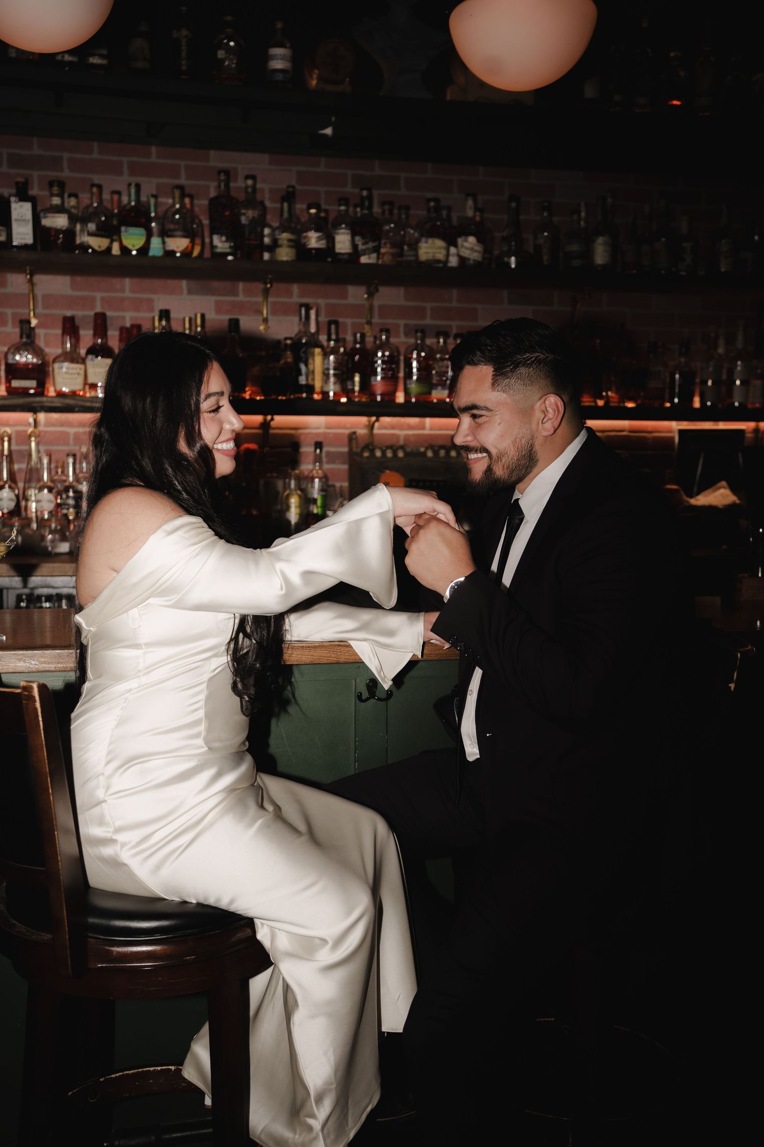 Two people dance energetically in a bar with dramatic lighting and vintage decor.