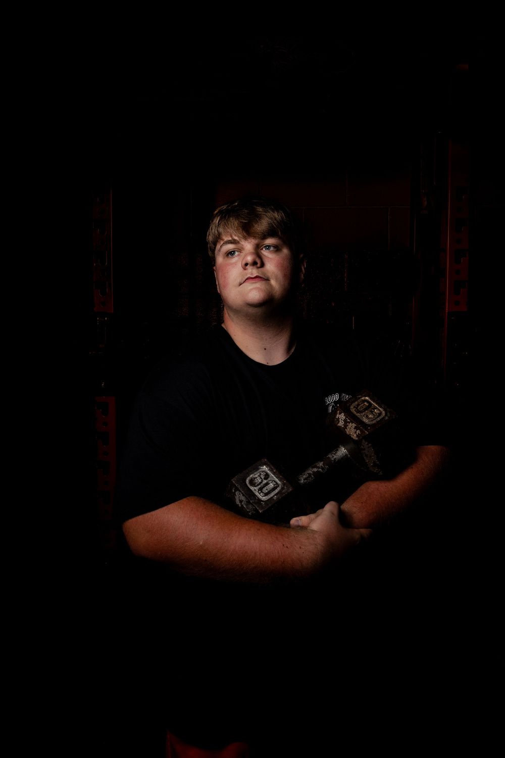 A sequence of dark dramatic portraits shows a person in a black t-shirt against a dark background.