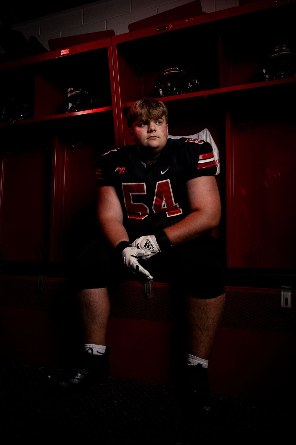 A series of athletic portraits showing someone in a black uniform against red and dark tones.