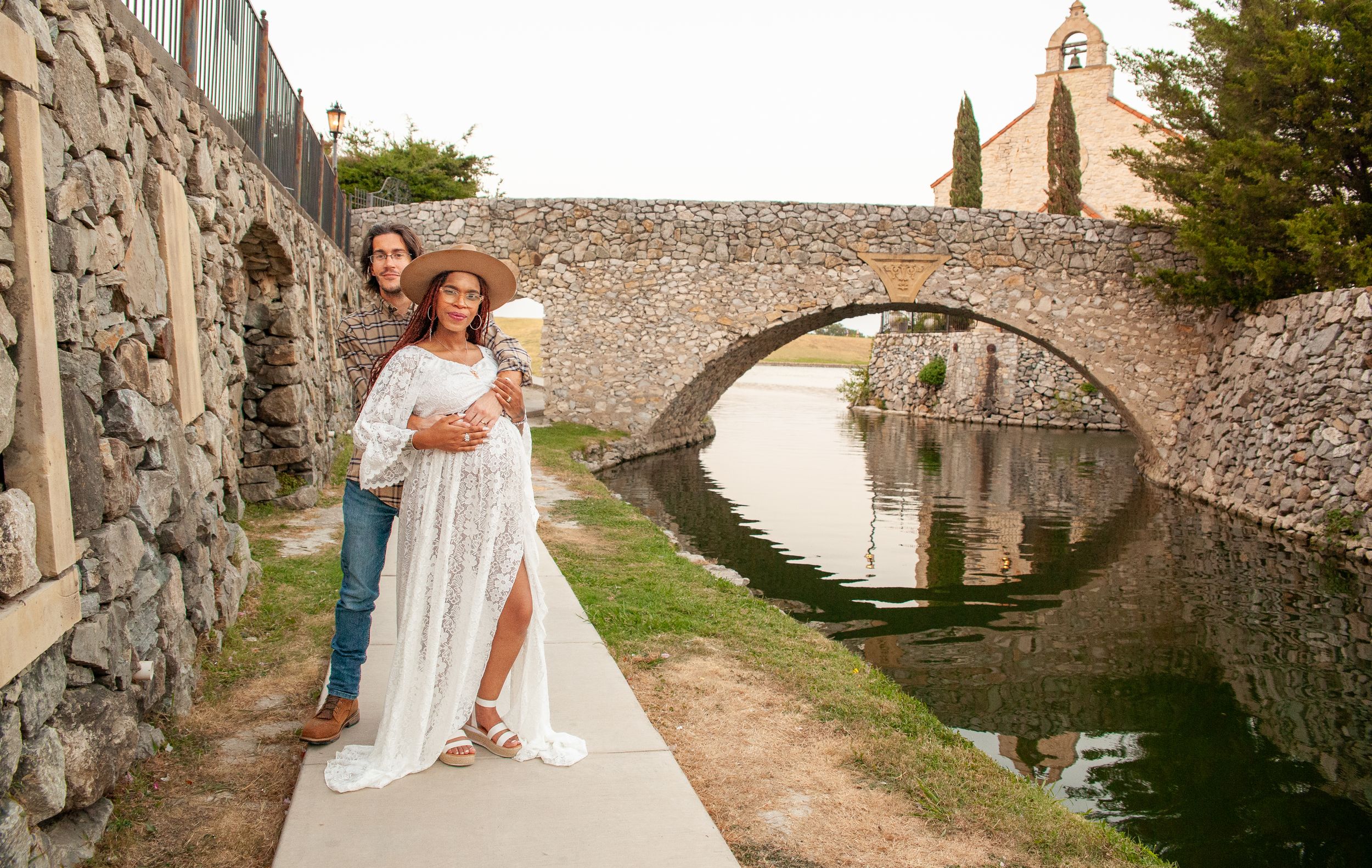 A romantic photoshoot along ancient stone walls and archways in warm sunlight.